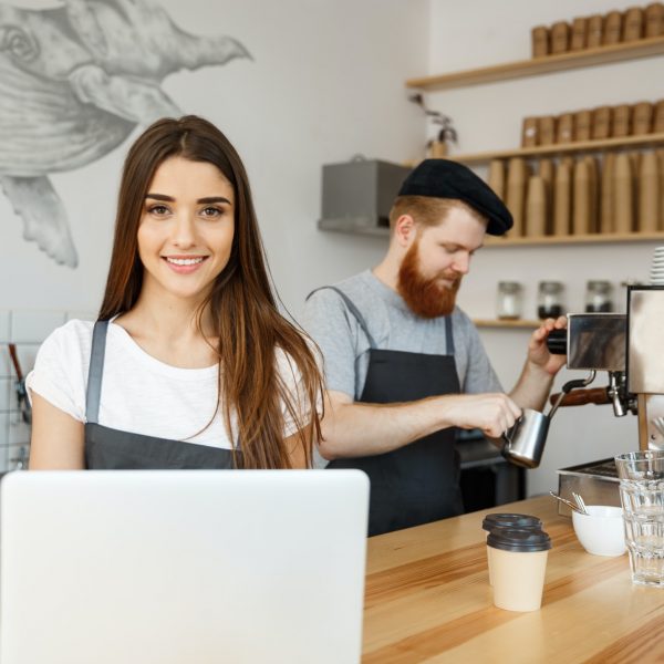 Coffee Business Concept - beautiful caucasian bartender barista or manager working and planing in