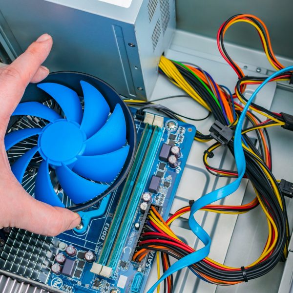Installing a processor fan on the computer motherboard. Computer repair, PC assembly